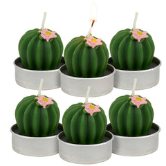 Set of six cactus-shaped candles with pink flowers in small metal pots on a white background