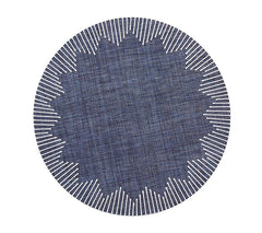 The Kim Seybert Dream Weaver Placemat Set of 4 in Navy & White features round placemats with a zigzag inner pattern and radiating white border lines for a striking sunburst effect against a plain background.