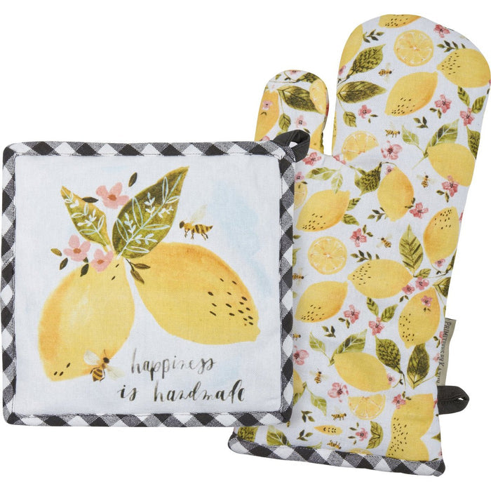 Set of kitchen items with lemon design including a pot holder, oven mitt, and towel.