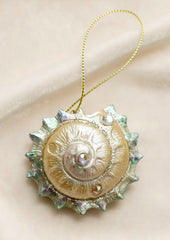 A nautilus shell ornament with pearlescent finish.