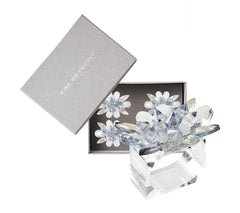 The Kim Seybert Spectra Napkin Ring Set of 4 in Glacier Blue features elegant crystal flower shapes, beautifully presented in a gray box—perfect for adding sophisticated style to your table décor.