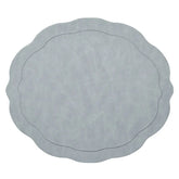 The Kim Seybert Tailored Placemat Set of 4 in Steel Grey features a light steel gray color, wavy edges, a subtle textured pattern, and an oval-shaped embossed border near the center.