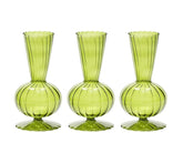 The Kim Seybert Tess Bud Vase Set of 3 in Olive features identical green glass vases with bulbous bases, narrow necks, flared openings, and elegant vertical stripes, arranged in a row against a white background.