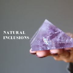 hand holding light purple amethyst pyramid