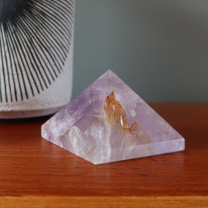 amethyst pyramid on table