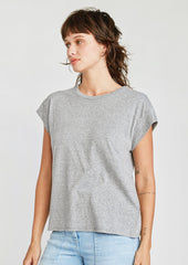 A woman wearing a cap sleeve muscle tee in heather grey color.