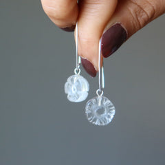 holding Clear Quartz in Daisy Flower shaped Earrings