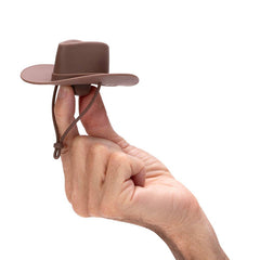 Hand holding a small brown cowboy hat against a white background