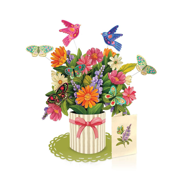 Colorful flower arrangement with butterflies and a card on a white background