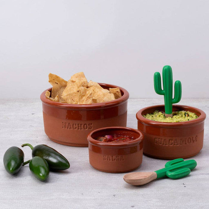 Set of terracotta bowls with cactus-themed handles for nachos, salsa, and guacamole on a light background.