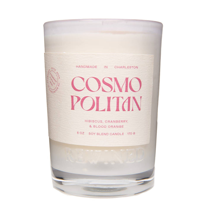 Candle with 'Cosmo Politan' text on a white background