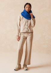 A pair of ecru wide leg jeans with vertical seam down front.