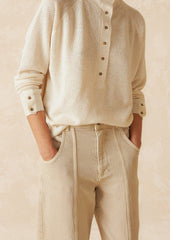 A pair of ecru wide leg jeans with vertical seam down front.