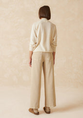 A pair of ecru wide leg jeans with vertical seam down front.