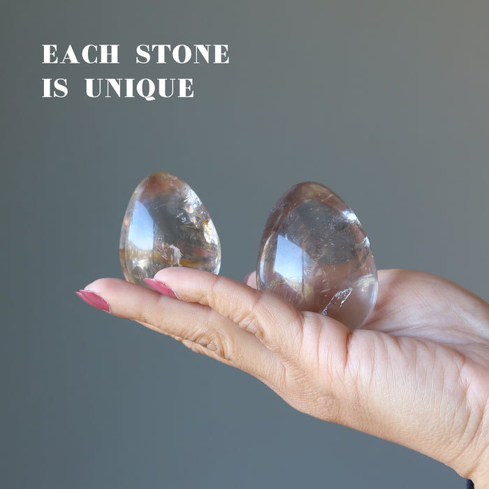 displaying 2 Smoky Quartz Eggs on the palm