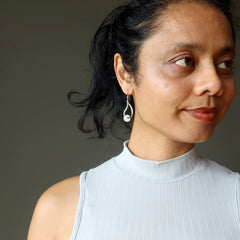 woman modeling snow quartz dangle earrings