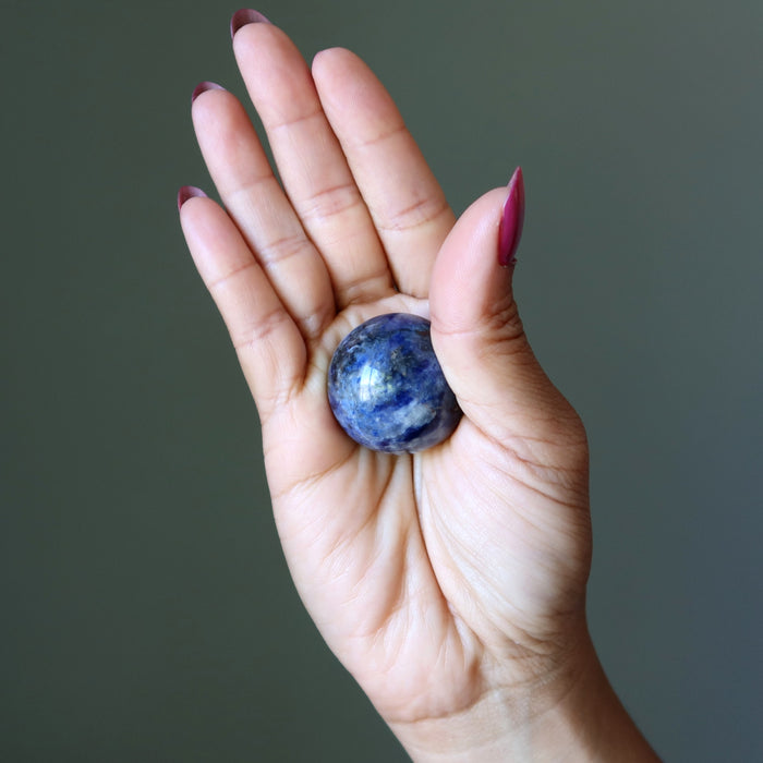 sodalite sphere in palm