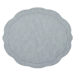 The Kim Seybert Tailored Placemat Set of 4 in Steel Grey features a light steel gray color, wavy edges, a subtle textured pattern, and an oval-shaped embossed border near the center.