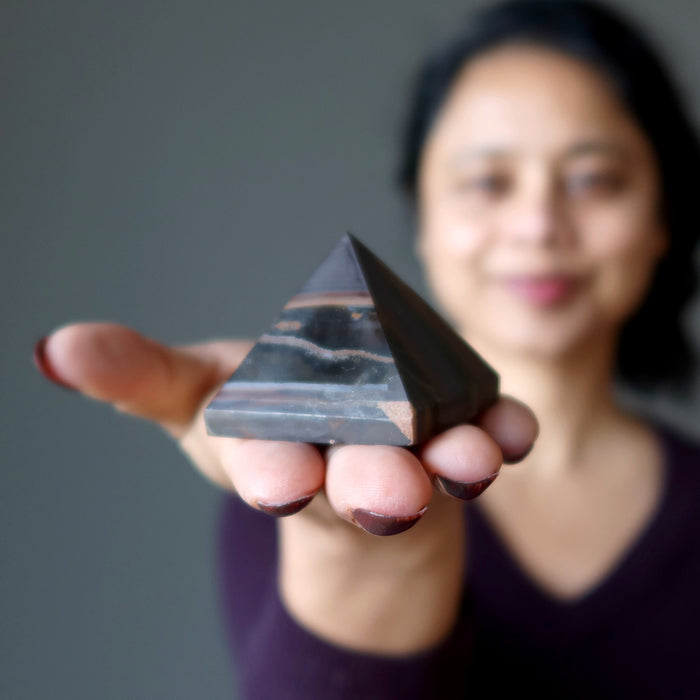 woman holding tiger iron pyramid