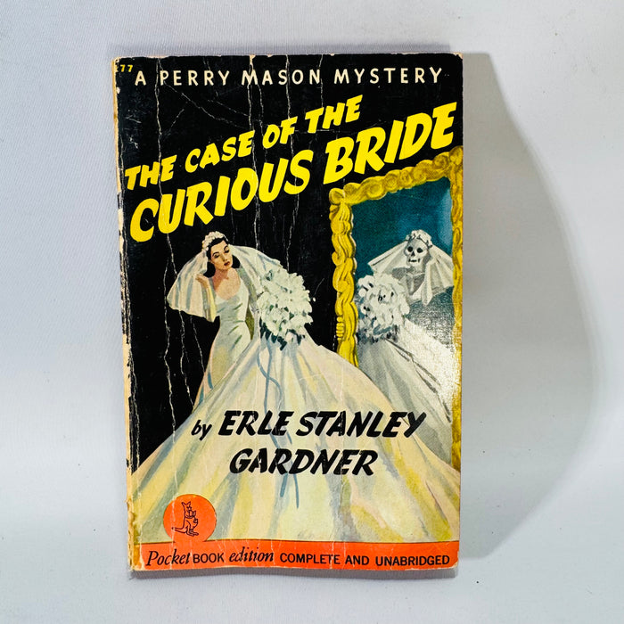 Vintage Perry Mason paperback The Case of the Curious Bride with dramatic pulp cover showing a bride and a spooky mirror reflection; visible creases and wear.