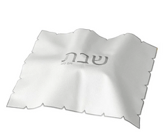 The BT-Shalom White Embroidered Leatherette Challah Cover—Silver features scalloped edges and central Hebrew text, making it an elegant Shabbat accent.